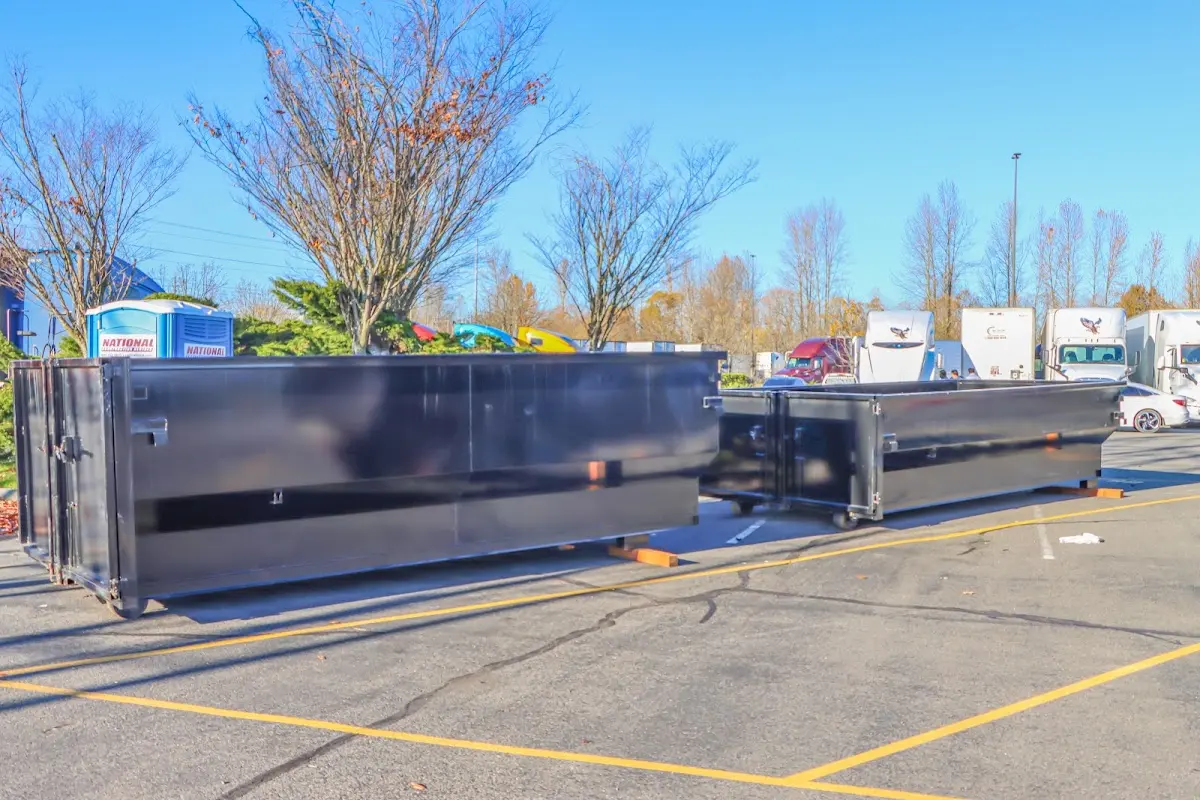 Professional dumpster rental service with roll-off container on residential driveway in South Miami Heights